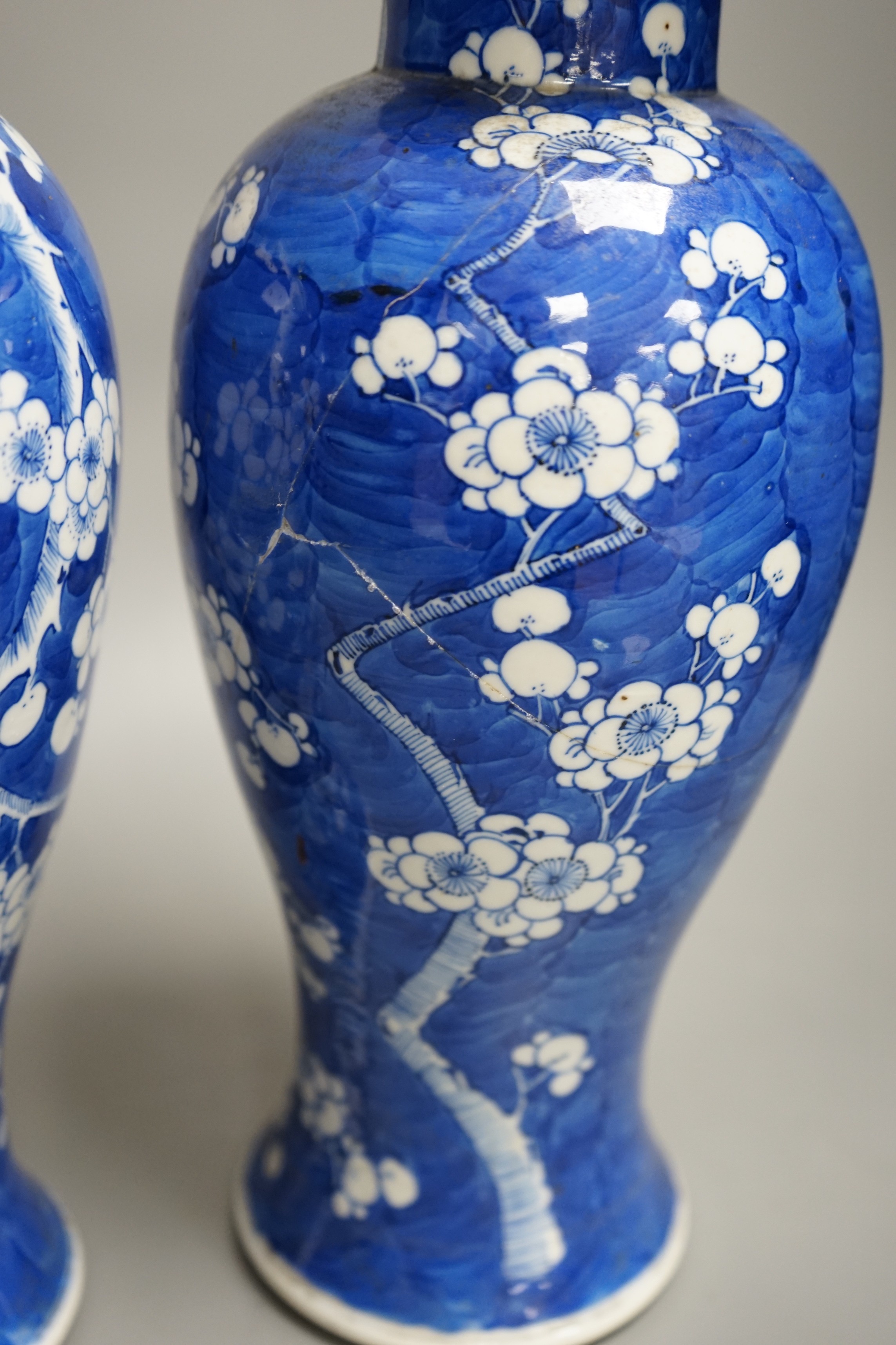 A pair of 19th century Chinese blue and white prunus vases, one a.f, 37cm